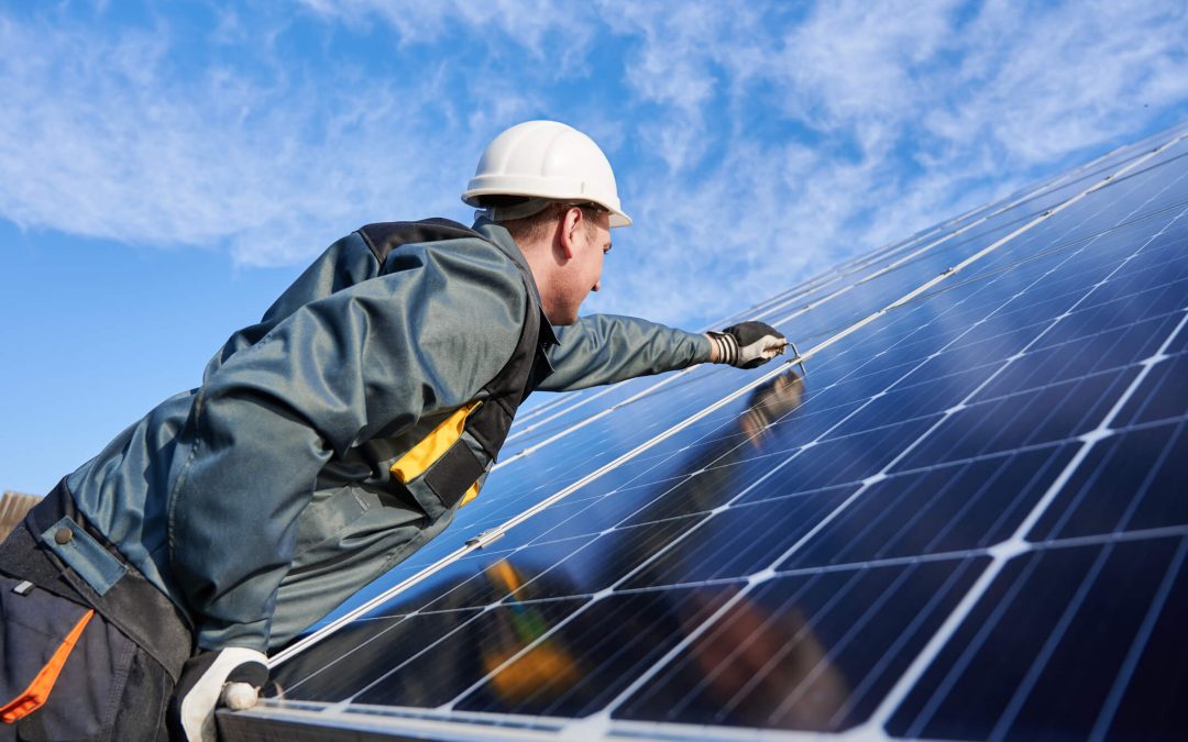Worker installing solar panels